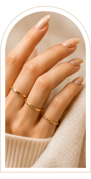 Elegant hand with gold rings and knit fabric